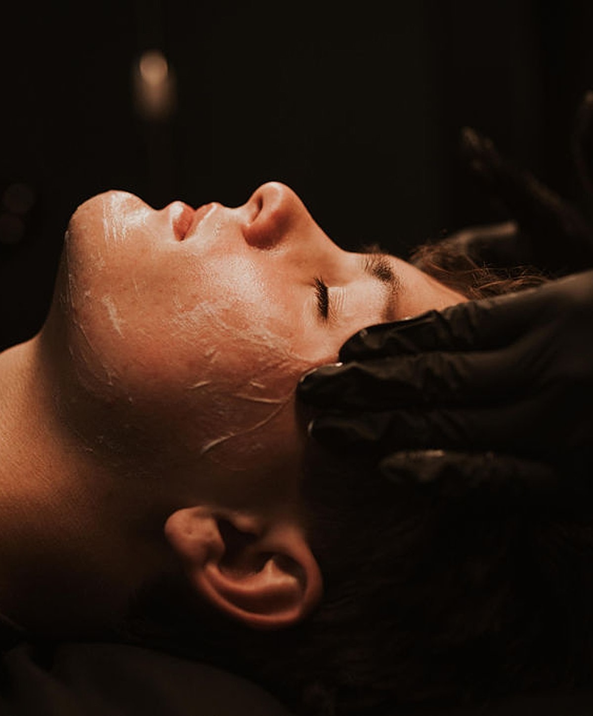 Person receiving a facial treatment in a spa.