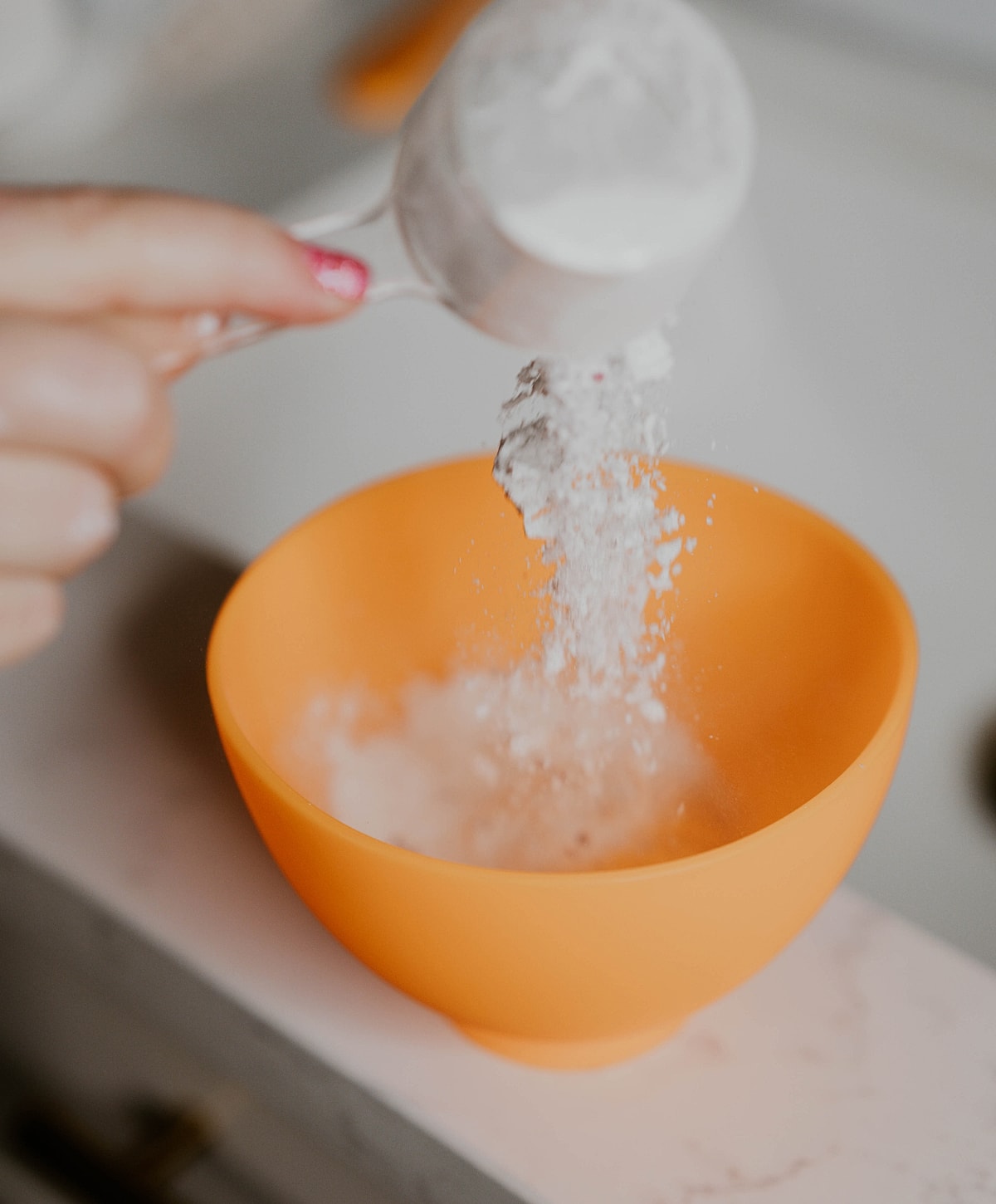 Facial treatment with exfoliating mask application.