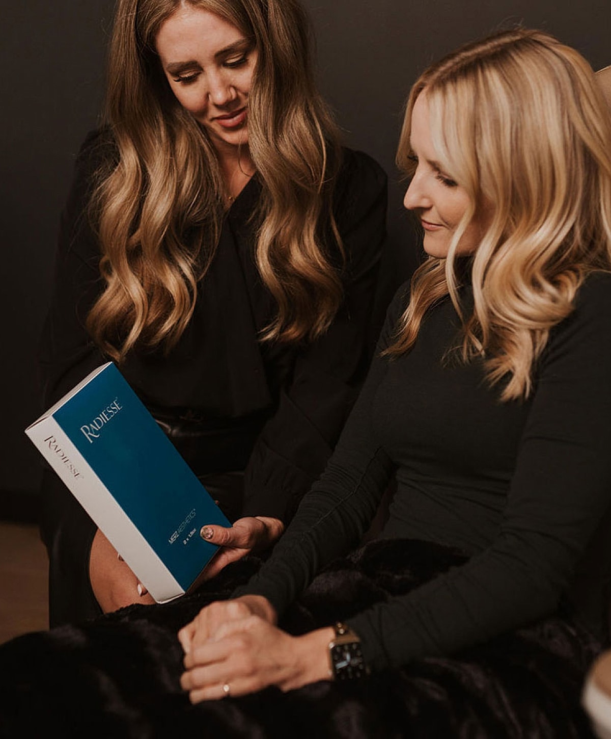 Women reading together with a book.