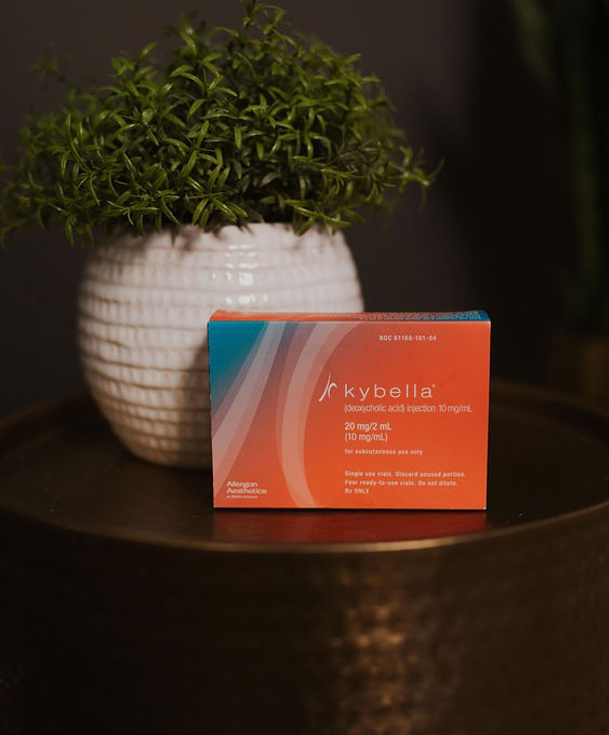 Kybella injection box next to a plant.