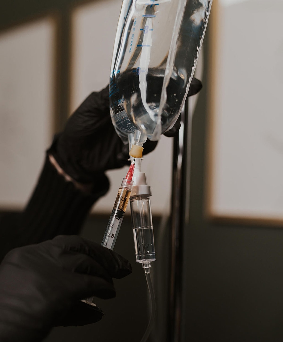 Administering medication through an IV setup.