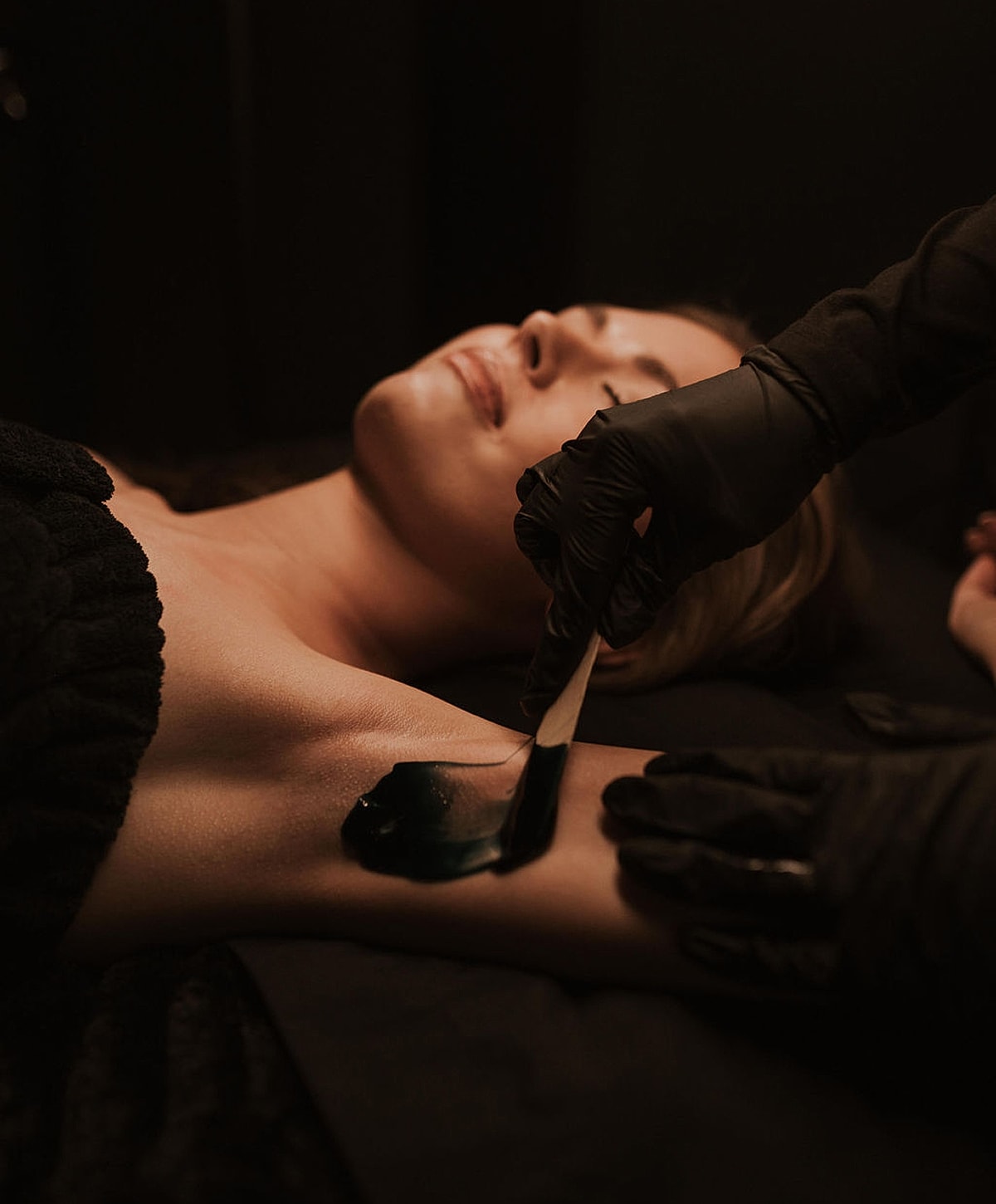 Waxing treatment on a woman's arm.