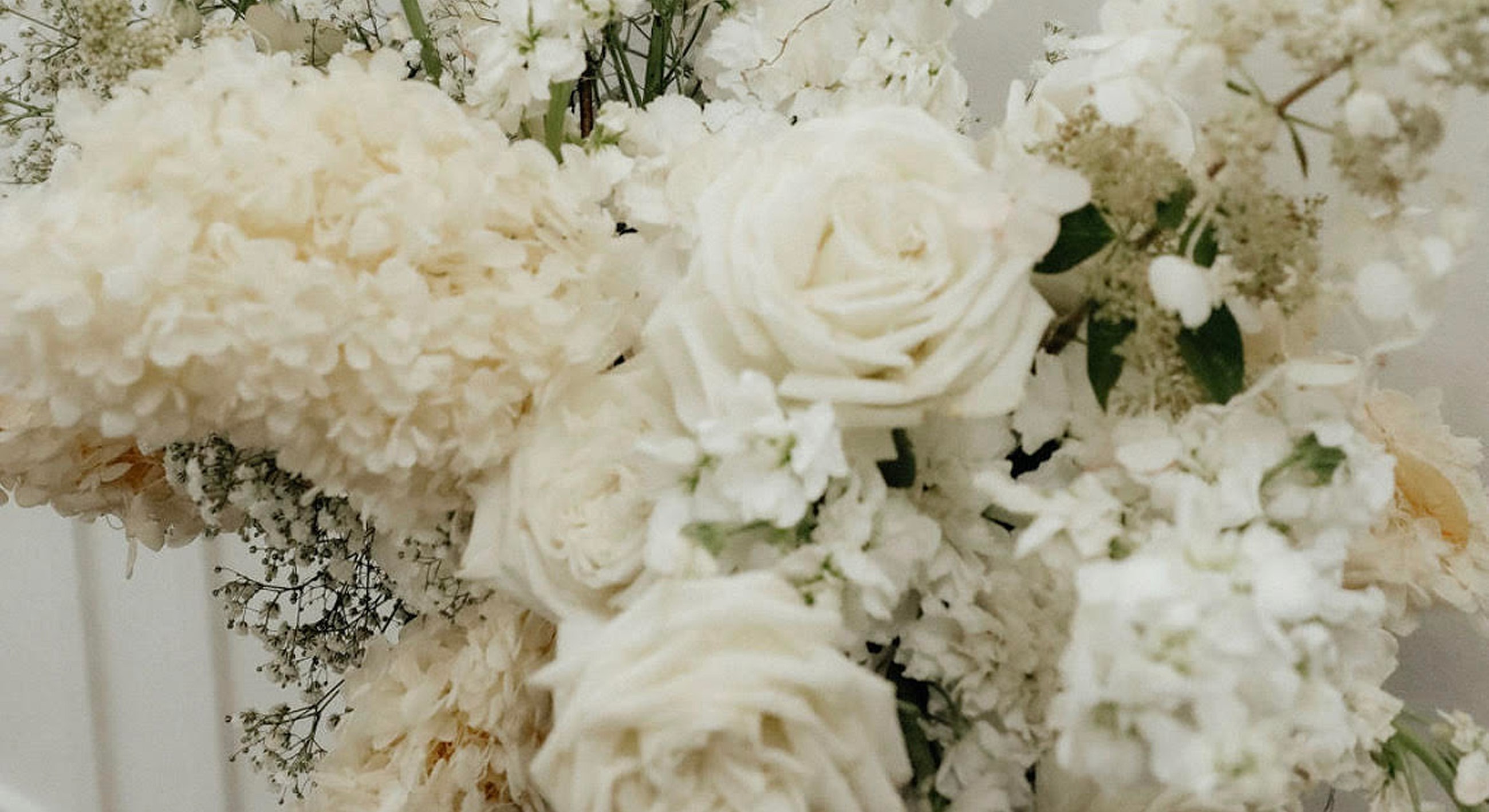 White floral bouquet with delicate blooms and greenery