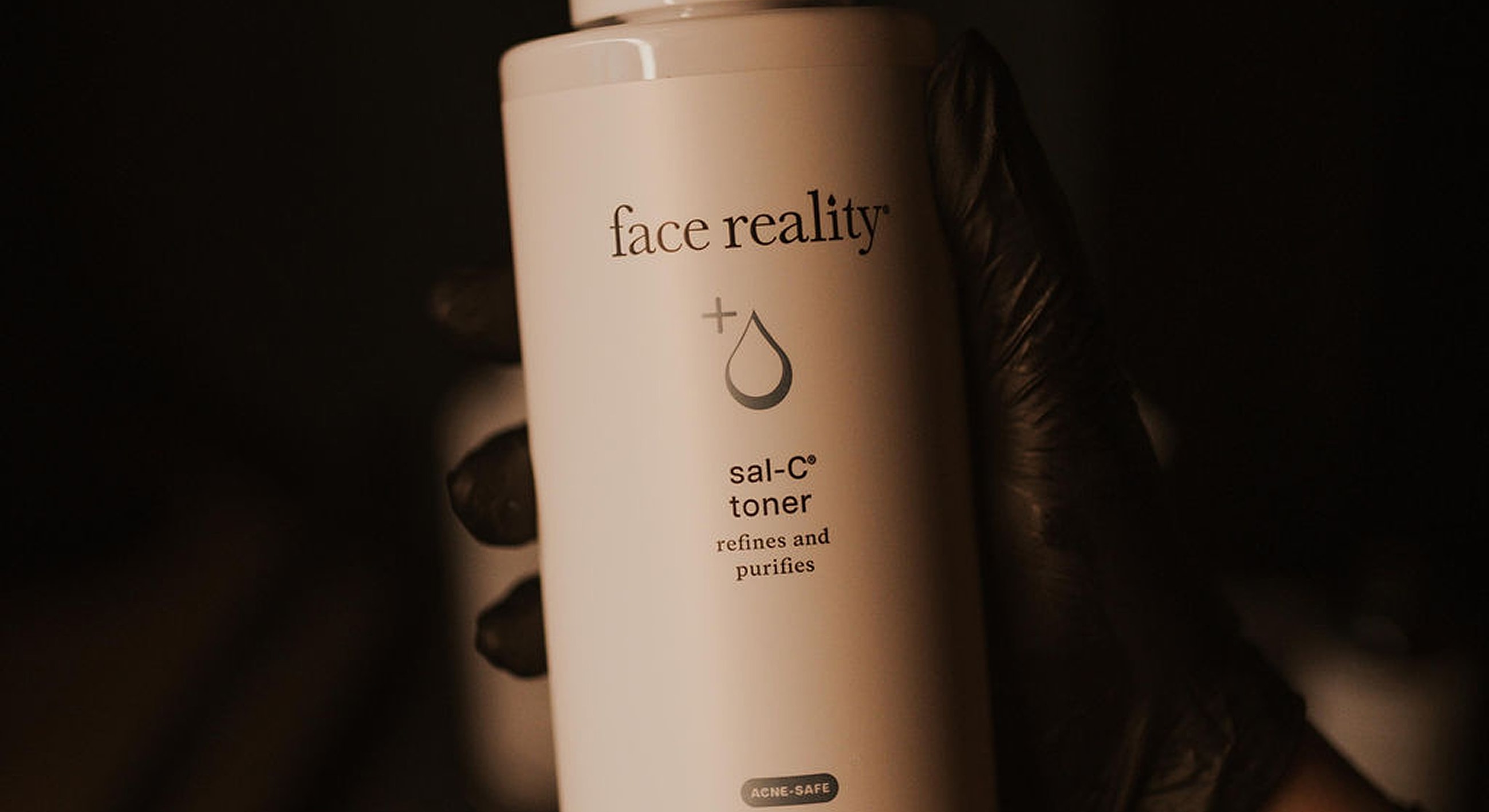 Face Reality sal-C toner bottle in hand.