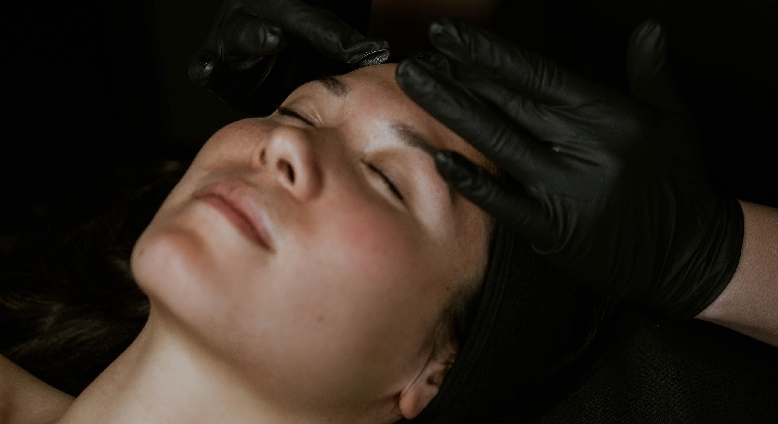 Eyebrow tinting process on a female client.